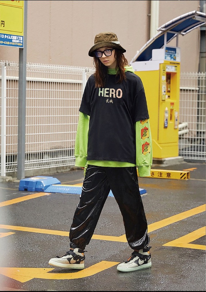Black HERO T-shirt layered over a green long-sleeved top